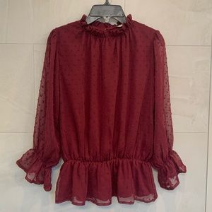 Super flattering long sleeve red blouse, the fabric is textured